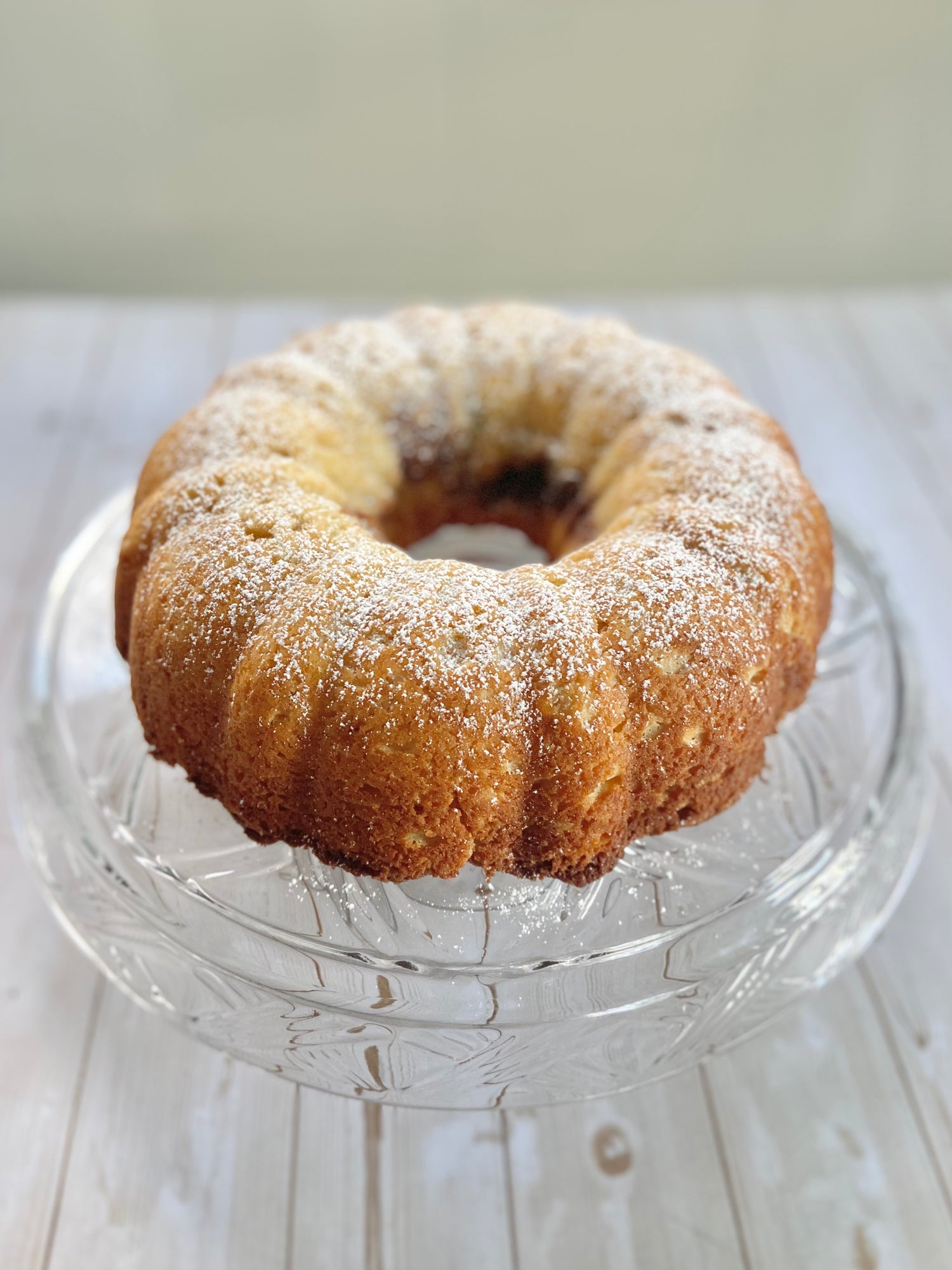 Bundt cake on clear glass pedestal.