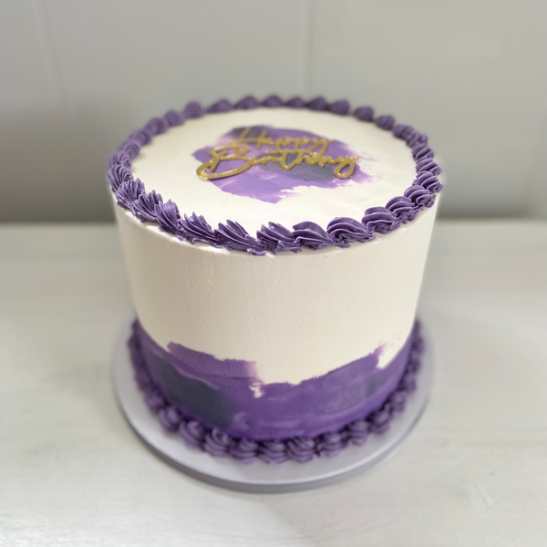 White cake with purple decorations on a white background