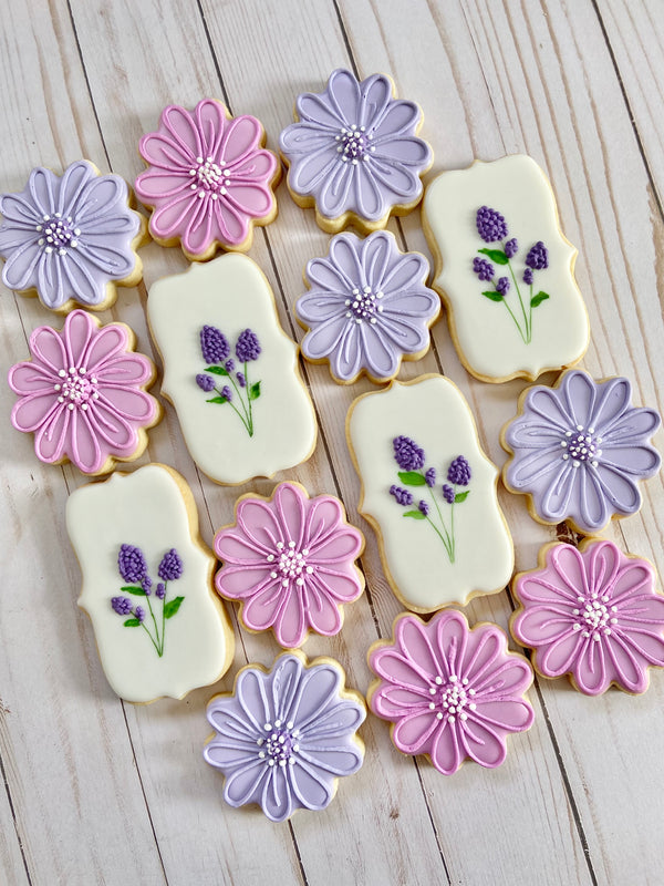 Spring daisy and lilac cookies decorated in shades of purple.