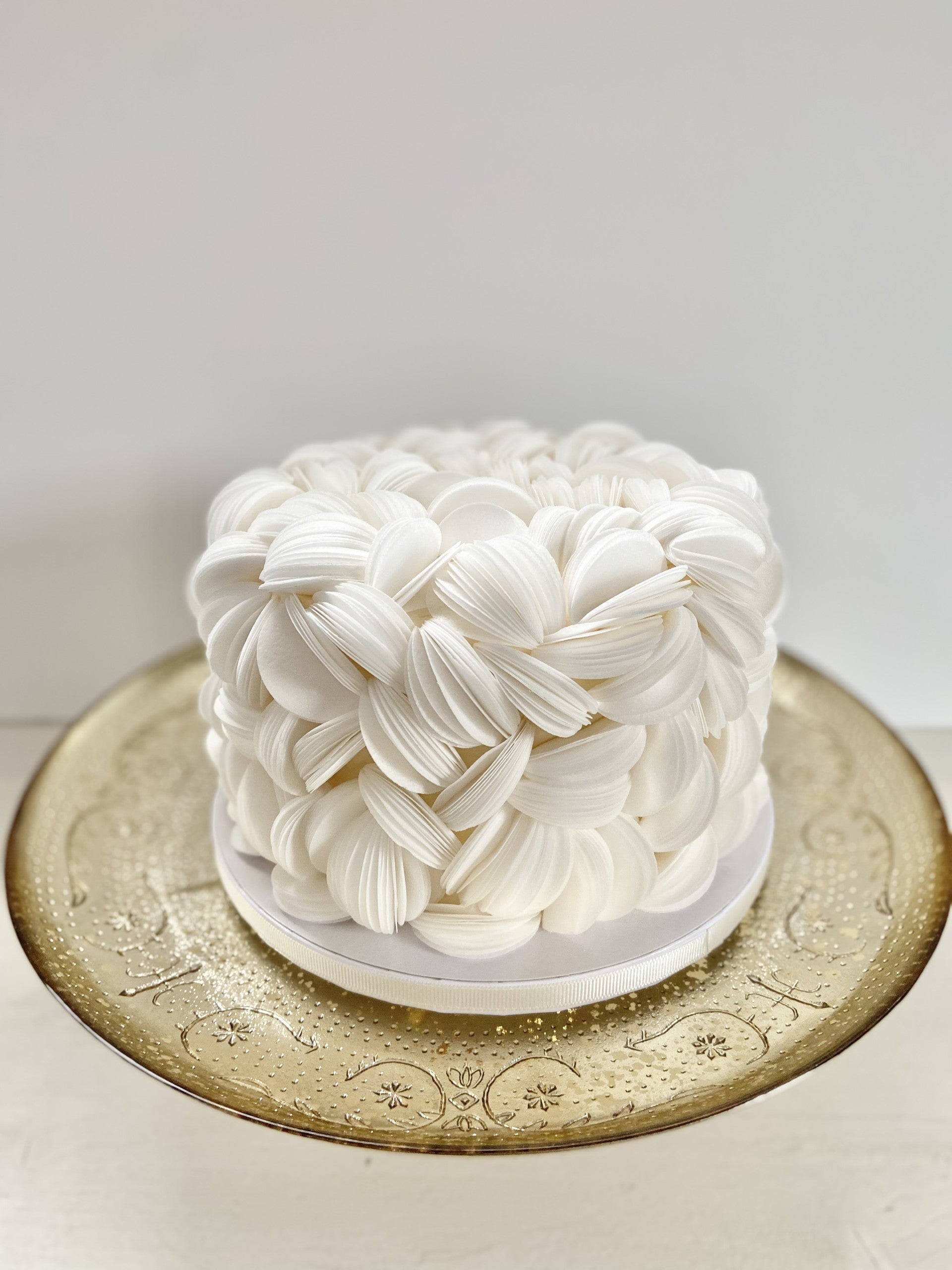 Small cake covered in white fluffy wafer paper.
